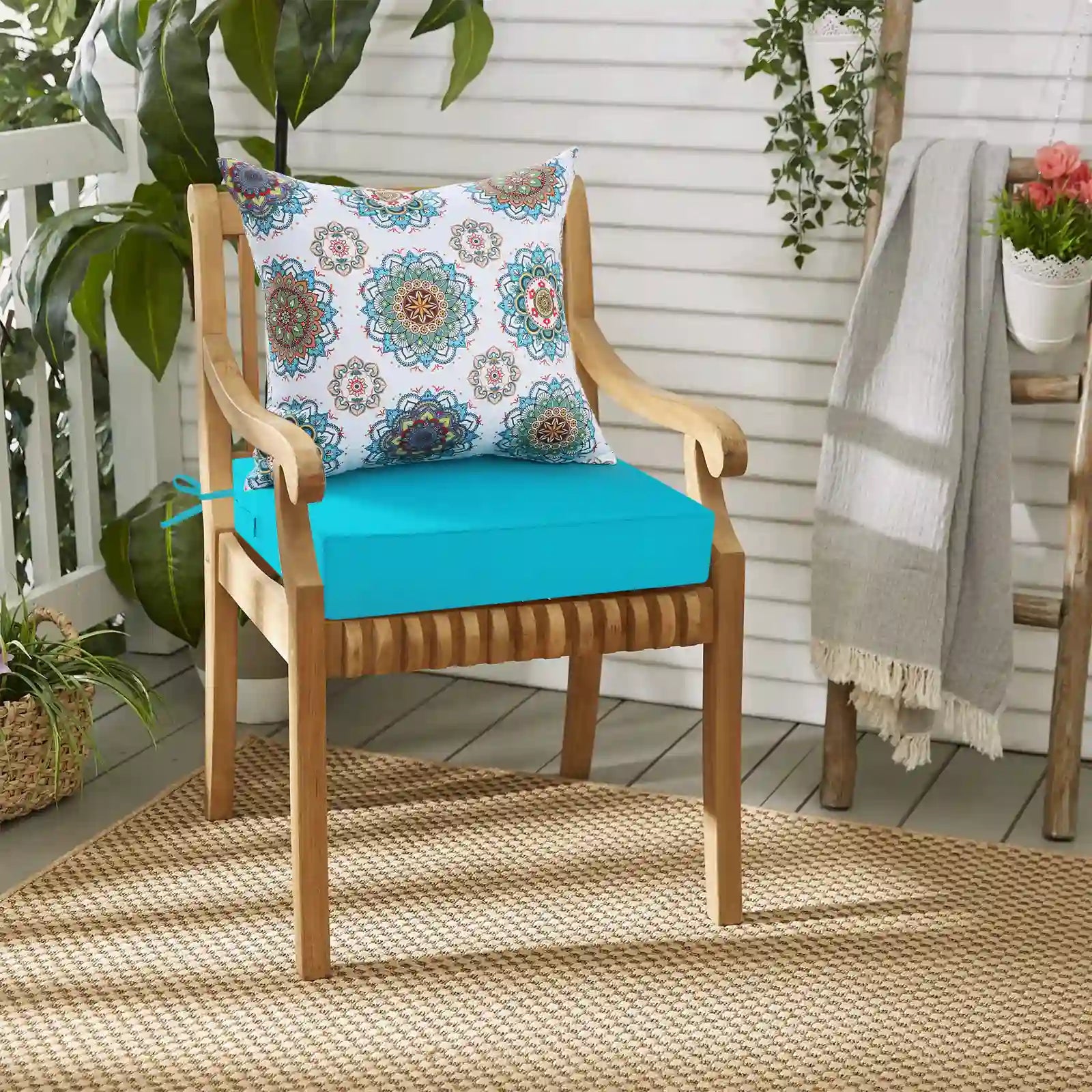 A piece of teal color yard & garden cushions is placed in a corner of the balcony